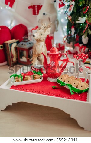 on a wooden tray beautiful napkin porcelain red teapot and cookies