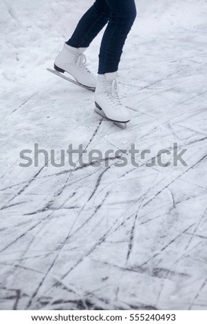 Girl's legs at ice skating outside