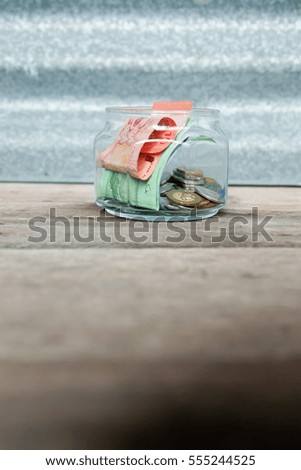 Money saving in the glass bottle for money concept
