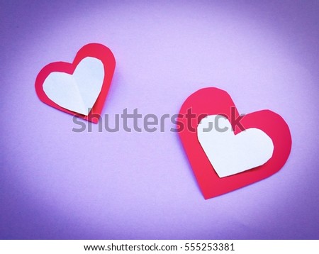 Fold paper Red White  hearts {Paper Heart stacked}, Heart of paper folding Isolated on Purple Background. Cards for Valentine's Day There is space for text "Happy Valentine's Day"