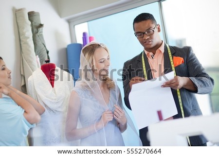 Dressmakers working with bride