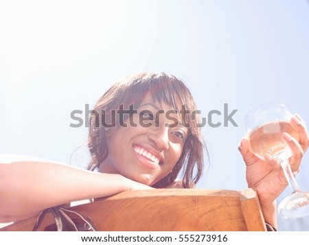 Smiling woman having wine outdoors