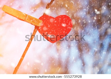 Red heart decoration hanging on a branchl grunge background, Valentine day concept. Toned