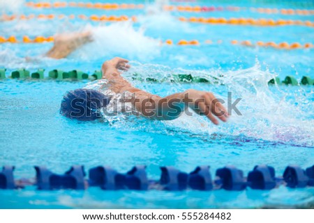 Blurry background of splash drop water on swimming race with swimming competition.