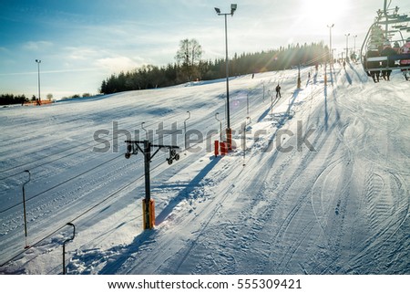People on chair and ski lift - Tylicz during winter ski season Royalty-Free Stock Photo #555309421