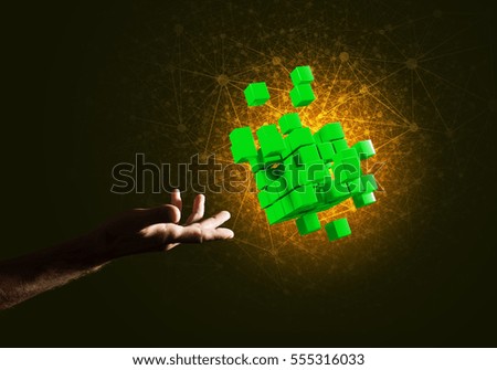 Close of man hand holding cube figure as symbol of innovation. 3D rendering