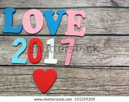 St valentines day 2017. 2017 love year. Love wooden letters and wooden date 2017 with red heart on wooden background. 
