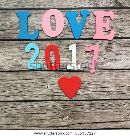 St valentines day 2017. 2017 love year. Love wooden letters and wooden date 2017 with red heart on wooden background. 