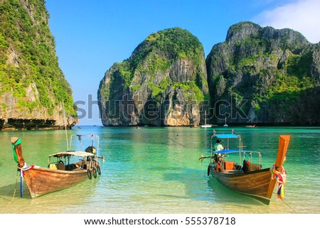 Longtail boats anchored at Maya Bay on Phi Phi Leh Island, Krabi Province, Thailand. It is part of Mu Ko Phi Phi National Park. Royalty-Free Stock Photo #555378718