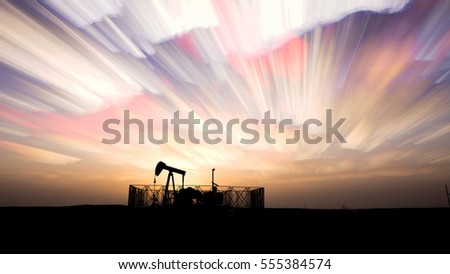 Silhouette of crude oil pump and clouds panning background