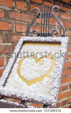 The symbol of the heart, painted on the fresh white snow.
