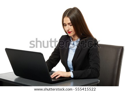 Young hispanic business woman typing on a laptop at her desk