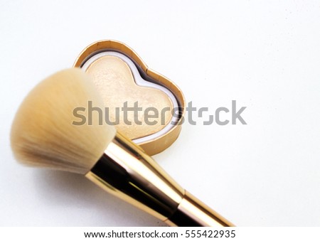 Makeup highlighter, make-up on Valentine's Day, shadow and brushes for make-up, make-up artist for the tools. Royalty-Free Stock Photo #555422935