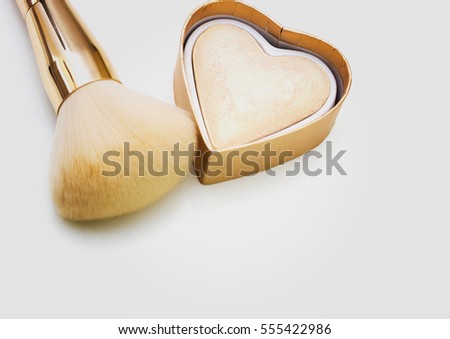 Makeup highlighter, make-up on Valentine's Day, shadow and brushes for make-up, make-up artist for the tools. Royalty-Free Stock Photo #555422986