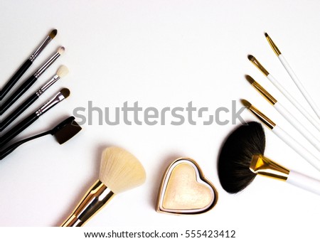 Makeup highlighter, make-up on Valentine's Day, shadow and brushes for make-up, make-up artist for the tools. Royalty-Free Stock Photo #555423412