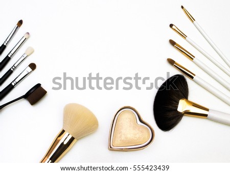 Makeup highlighter, make-up on Valentine's Day, shadow and brushes for make-up, make-up artist for the tools. Royalty-Free Stock Photo #555423439
