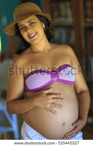 Pregnant woman in a bikini 