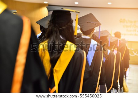 The back of the graduates are walking to attend the graduation ceremony at the university,Concept of Successful Education in Hight School,Congratulated Degree  Royalty-Free Stock Photo #555450025