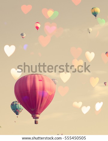 Vintage hot air balloons with bokeh hearts