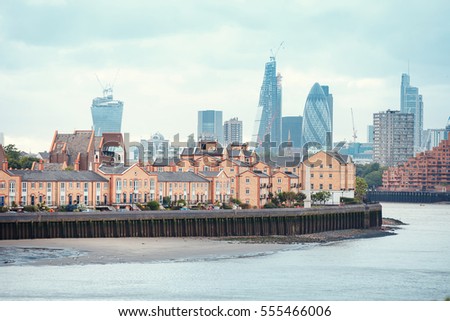 View of London Docklands with the Thames River, downtown, cucumber and city center. Real estate buildings suburbs Royalty-Free Stock Photo #555466006