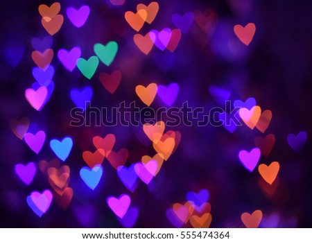 Many multicolored blurred hearts. Valentines day background with figured bokeh.