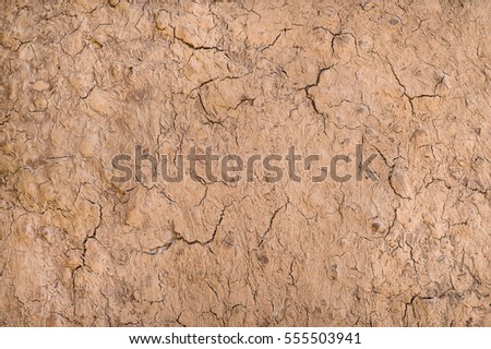 Old cracked wall made of clay.