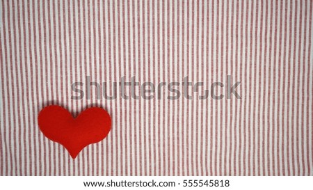 Heart shape on red and white stripes background  for Valentines day.