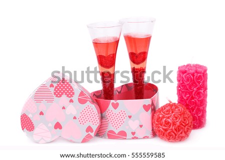 Two glasses, candles, gift box  isolated on white background.