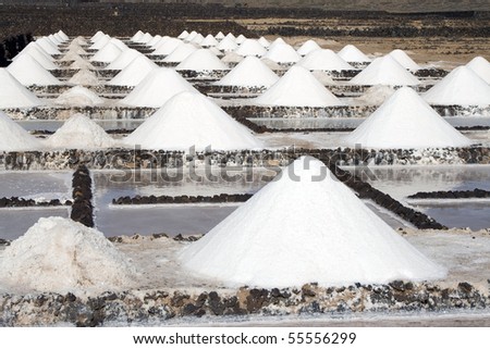 Salt piles on a saline exploration in Janubio, Lanzarote Royalty-Free Stock Photo #55556299