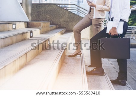 Moment Businessman running fast upstairs. Horizontal outdoors shot,image leg walking up stairs in city to success,Space for copy text. Royalty-Free Stock Photo #555569410