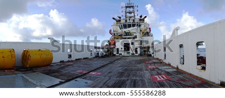 Panorama of Anchor Handling Tug (AHT) vessel. The space where marine crew strorage industrial cargo and perform anchor handling activities. Royalty-Free Stock Photo #555586288
