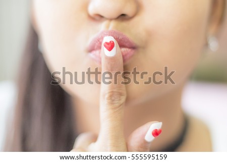 Happy women finger nails painted red heart shape, Valentine concept