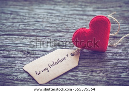 red heart shape with be my valentine text on paper tag over wooden table background ,vintage color tone, Image for Happy valentine day concept.