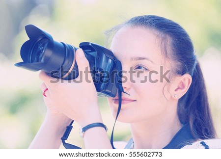 beautiful european female photographer with camera outdoor