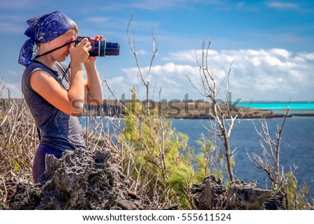 Girl taking photo of birds on the northern peninsula near Diego Suarez