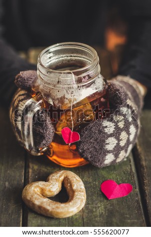 cup of tea with gingerbread heart and heart shaped dessert