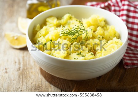 Potato salad with fresh dill in white bowl