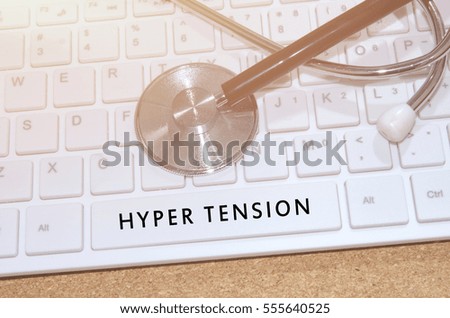 Medical Concept. Word Hyper Tension on white keyboard and stethoscope on table.