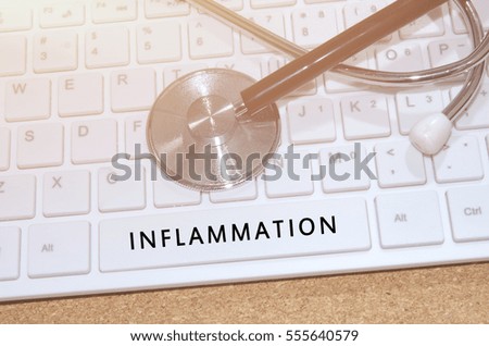 Medical Concept. Word Inflammation on white keyboard and stethoscope on table.