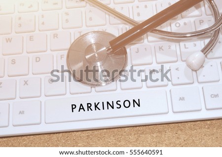 Medical Concept. Word Parkinson on white keyboard and stethoscope on table.