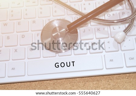Medical Concept. Word Gout on white keyboard and stethoscope on table.