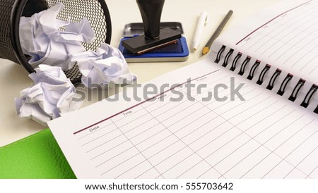 A book,crumpled paper and rubber stamp. Business meeting conceptual.
