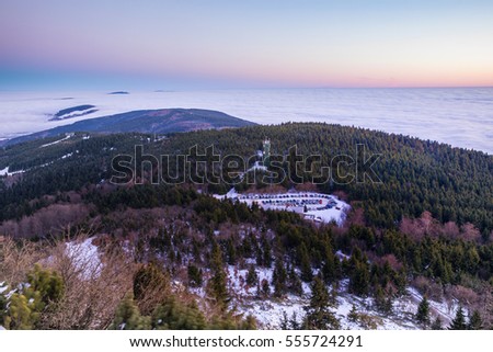 After Colorful sunset with inversion in the valley below Jested in North Bohemia. Aerial view from top of Jested. Czech Republic.