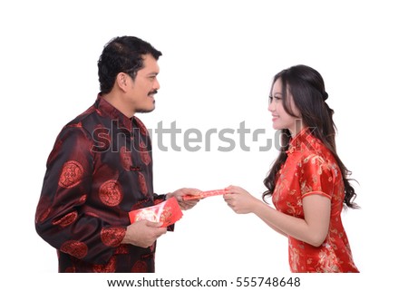 Asian man with tang suit give red envelope to asian girl with cheongsam symbolic chinese new year concept, model isolated on white background.