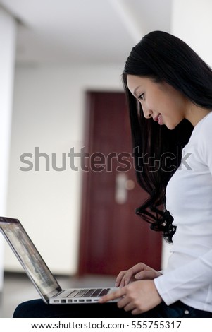 	Young woman using laptop	