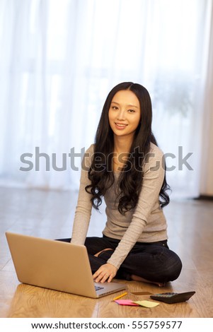	Young woman shopping online with credit card	