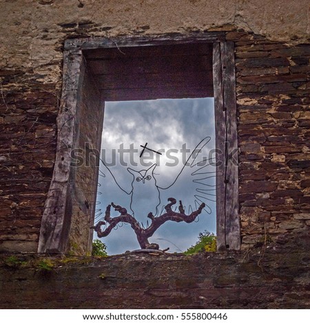 picture at an old castle - an owl shows down from the window