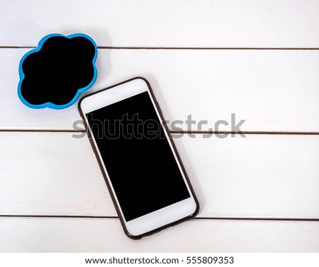 mobile phone on white chair background with small board cloudt , black space for insert text or image
