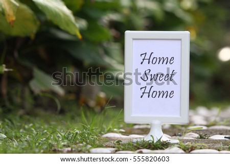 Conceptual image with word Home Sweet Home at the garden.