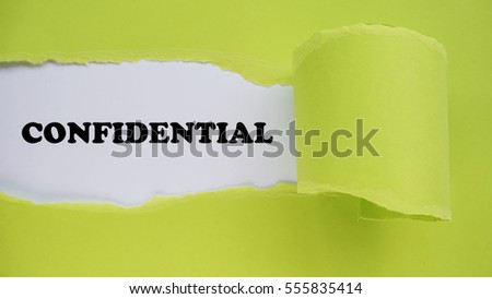 CONFIDENTIAL ! text written on a green pieces of torn paper. Suitable for OFFICE terms.
